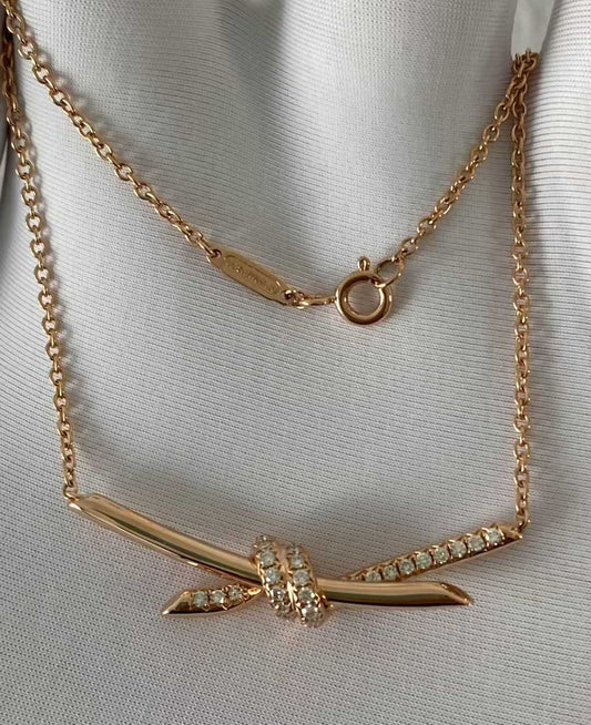“Authentic Tiffany & Co. Knot necklace on white background”