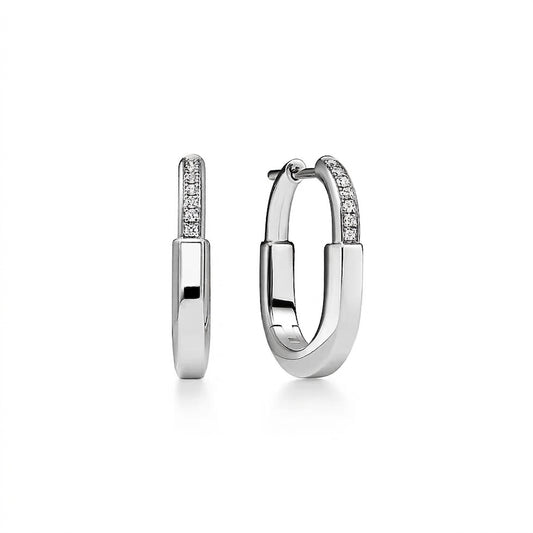 A pair of polished silver hoop earrings with a pavé-set diamond band on the front, shown on a clean white background.