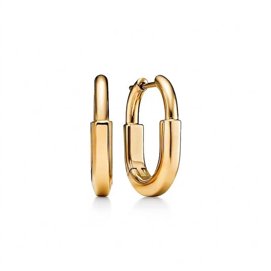 A pair of polished gold huggie hoop earrings shown from the front and side against a clean white background.