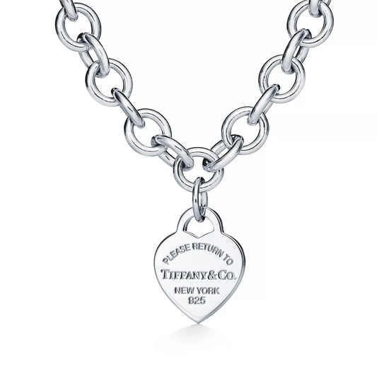 Silver chain necklace with a heart-shaped tag featuring Tiffany & Co. branding on a white background.