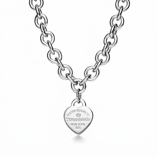 Silver chain necklace with a heart-shaped tag on a white background