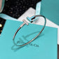 Silver bracelet with a blue accent on a Tiffany & Co. box