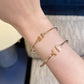 Gold bracelet on a wrist with a blurred background