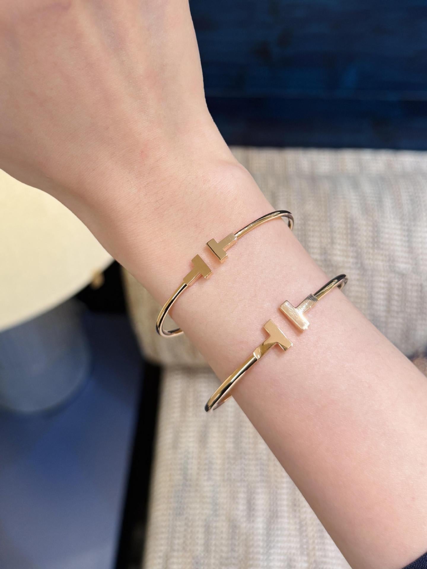 Gold bracelet on a wrist with a blurred background