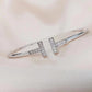 Silver bracelet with small diamonds on a soft pink background