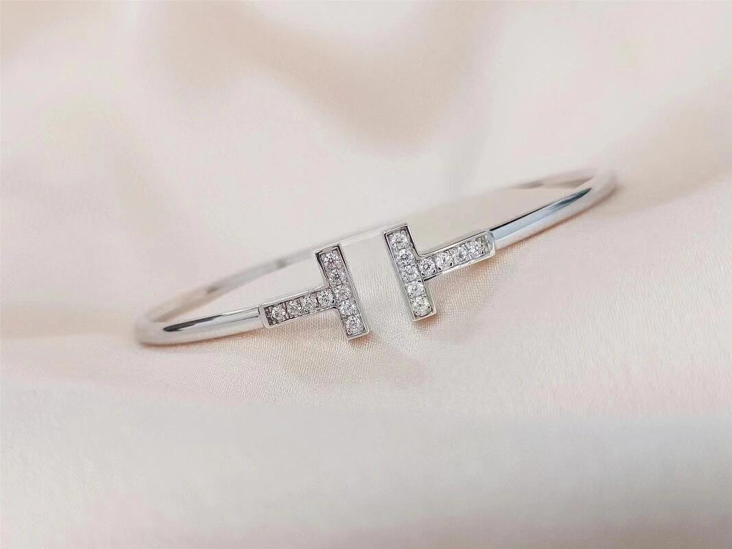 Silver bracelet with small diamonds on a soft pink background