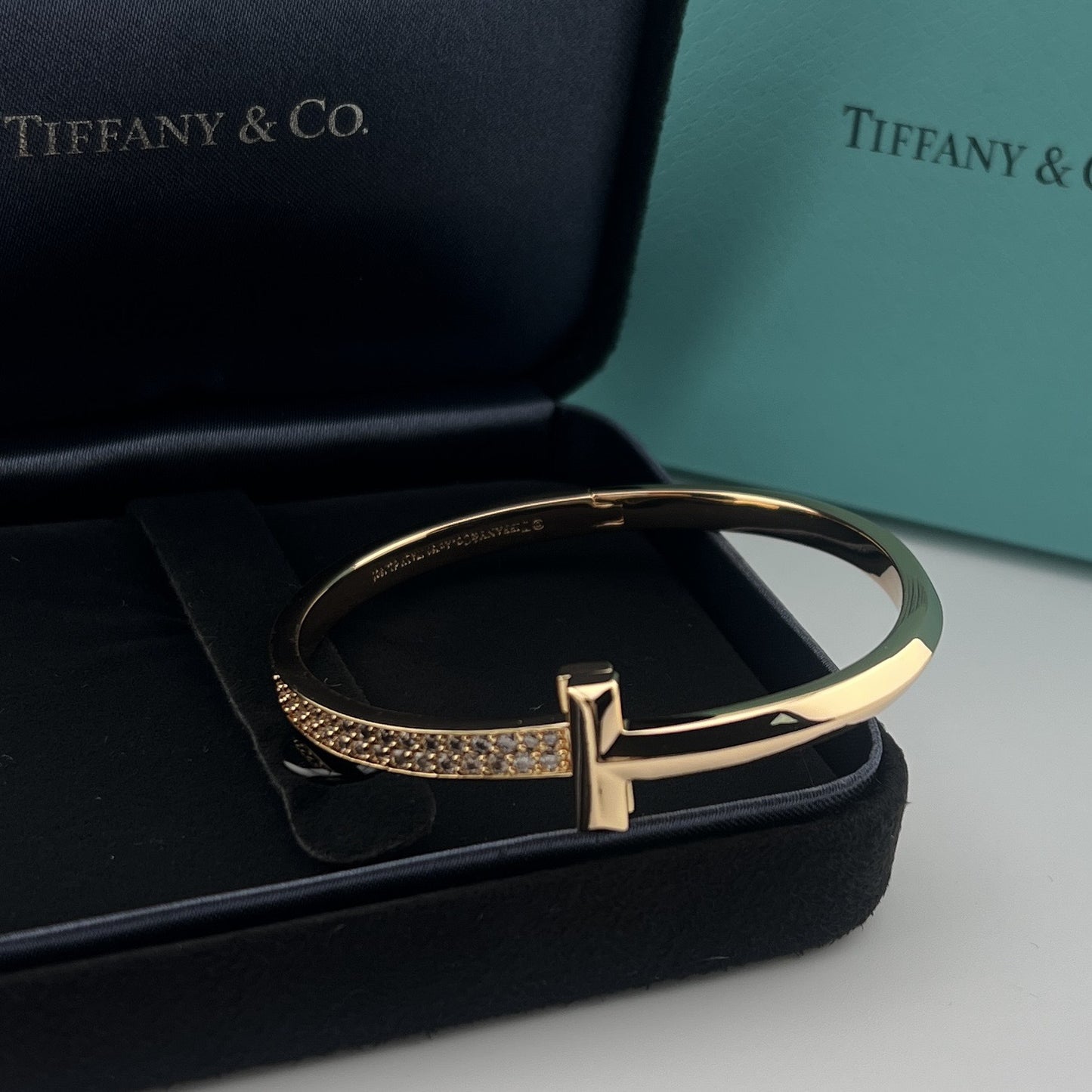 Gold bracelet on a black Tiffany & Co box