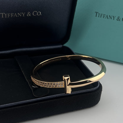 Gold bracelet on a black Tiffany & Co box