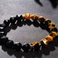 Bracelet with black and yellow beads on a textured surface