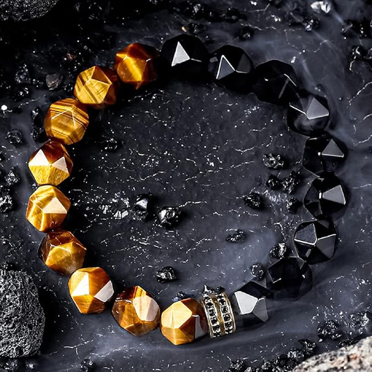 Bracelet with gold and black beads on a dark textured surface