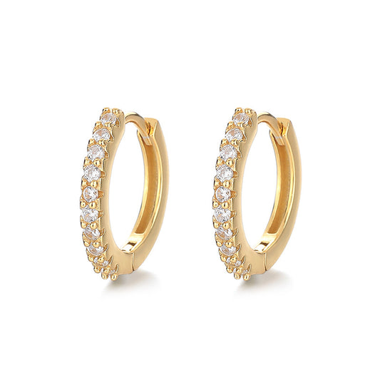 Gold hoop earrings with clear gemstones on a white background