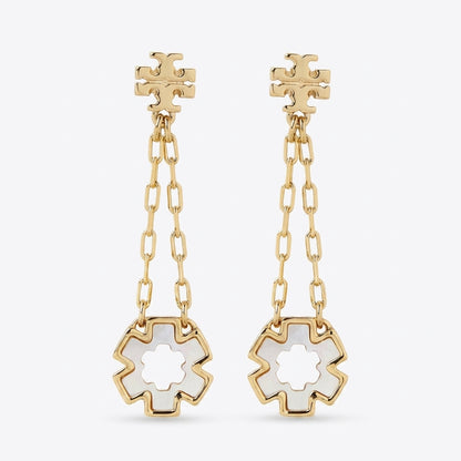 A pair of gold dangle earrings with a geometric flower-shaped stud, a short chain link drop, and a larger matching flower pendant with a white inlay, shown on a light gray background.