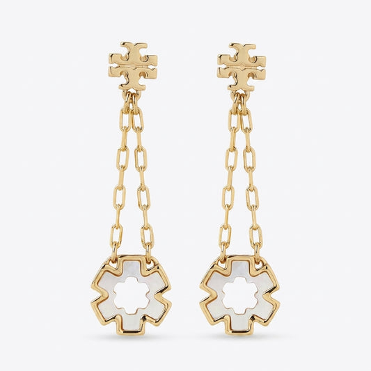 A pair of gold dangle earrings with a geometric flower-shaped stud, a short chain link drop, and a larger matching flower pendant with a white inlay, shown on a light gray background.