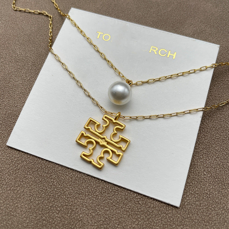 Necklace laid flat in a “Y” shape on a neutral background, clearly displaying the dual chain structure and adjustable closure.