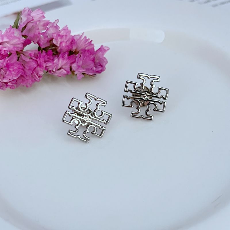 Both studs displayed face-up on a clean, light background (white or pale gray), clearly showing the Double T logo and polished finish.