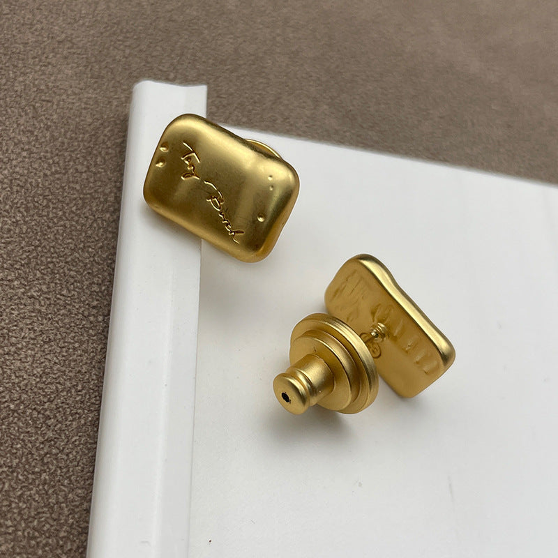 Close-up focusing on the material contrast—like glossy resin against gold metal, or intricate crystal/ enamel detailing.