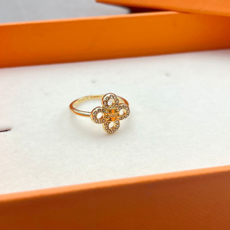 Close-up focused on a single clover design, highlighting engraved lines, metal texture, and overall craftsmanship.