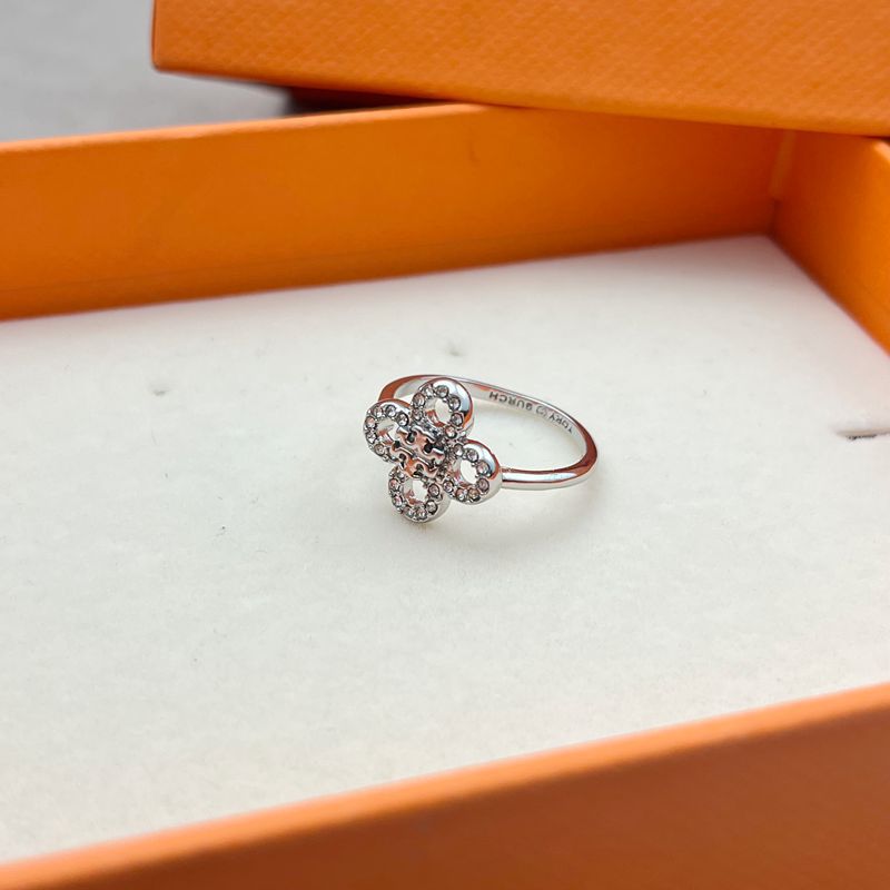 Close-up focused on a single clover design, highlighting engraved lines, metal texture, and overall craftsmanship.