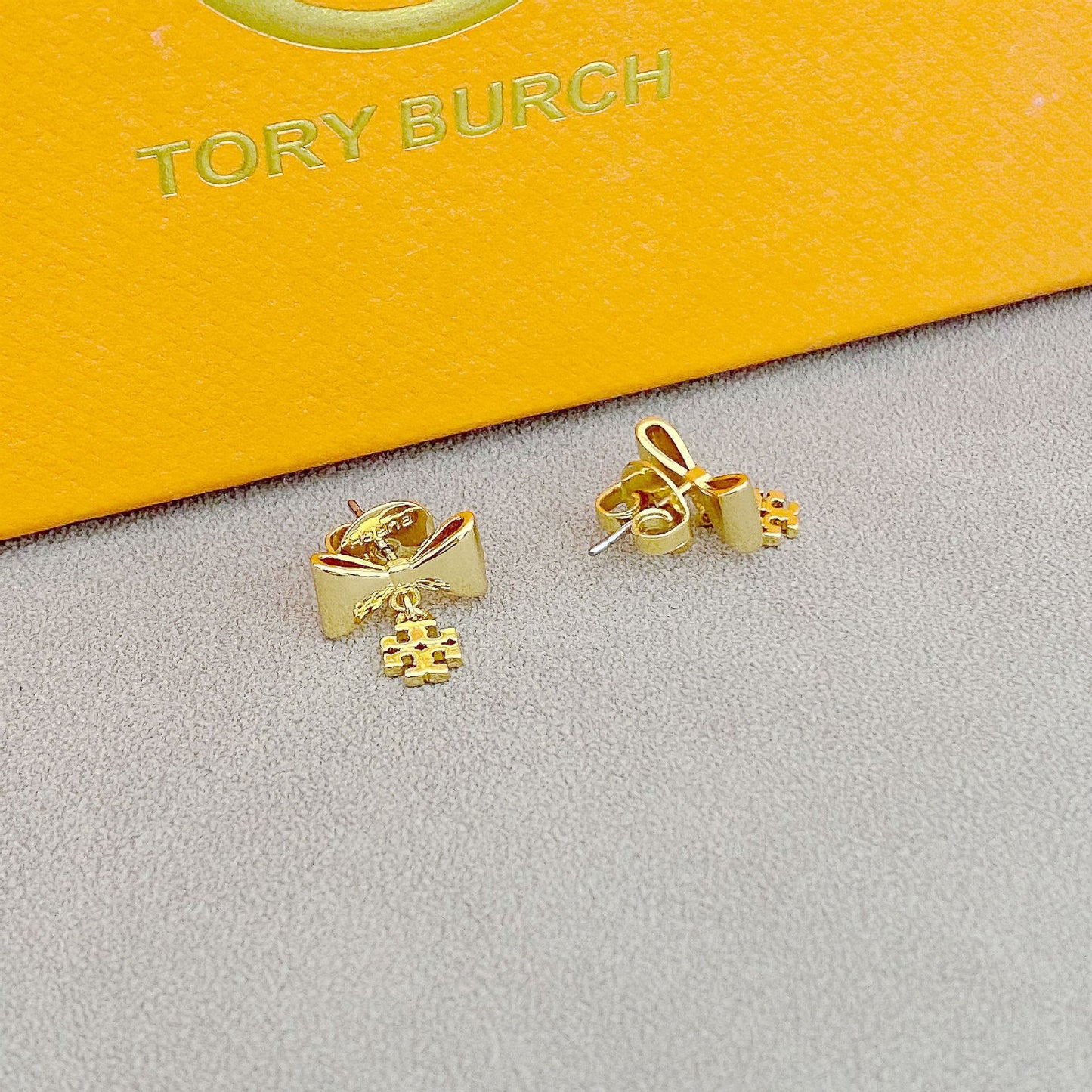 High-definition shot of the pair of earrings laid flat on pure white background, arranged symmetrically.