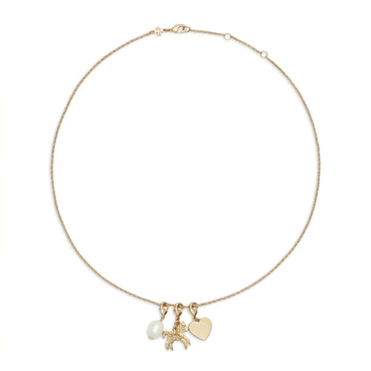A delicate gold chain necklace featuring three charms: a small white pearl, a gold horse charm, and a flat gold heart pendant, displayed on a clean white background.