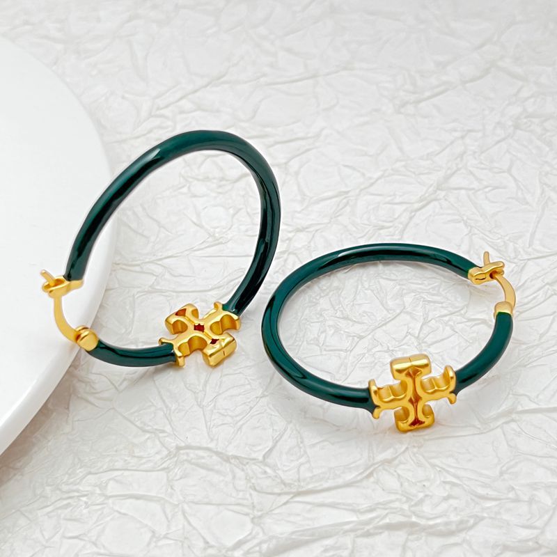  Macro shot tightly focused on the Double T logo link, highlighting its detailed engraving and polished finish.