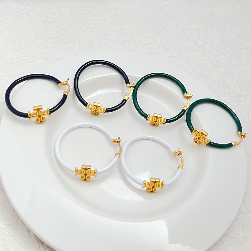 Clean, front-facing shot of a single hoop against a neutral background, clearly displaying the Double T logo as a distinct element within the hoop's circle.