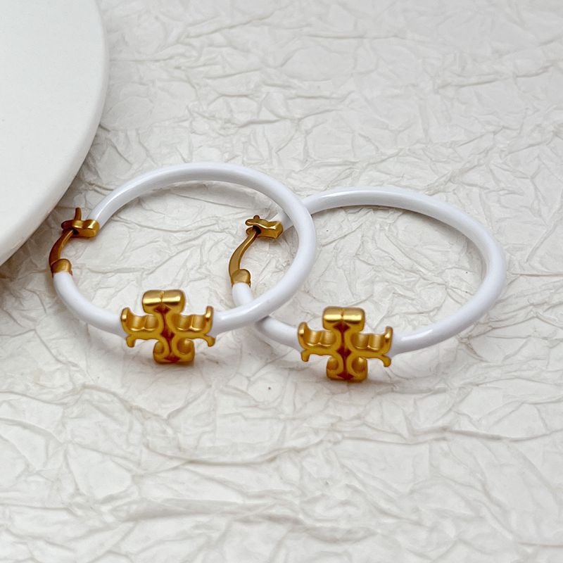  Clean, front-facing shot of a single hoop against a neutral background, clearly displaying the Double T logo as a distinct element within the hoop's circle.