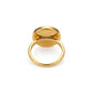 A polished gold signet ring with a flat oval face, shown from a top-down angle on a clean white background.