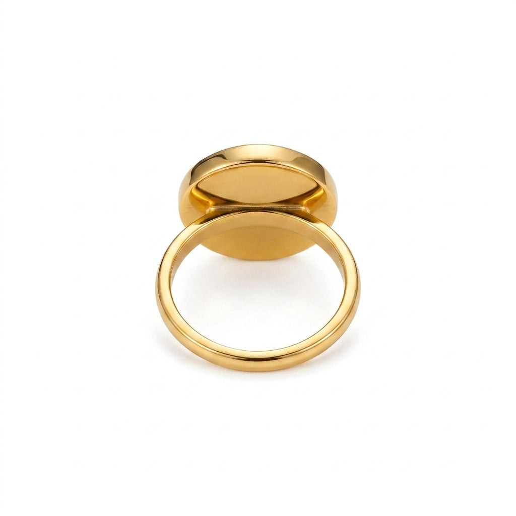 A polished gold signet ring with a flat oval face, shown from a top-down angle on a clean white background.