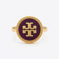 A gold signet ring featuring a circular dark purple enamel face with a raised gold monogram logo, set against a clean white background.