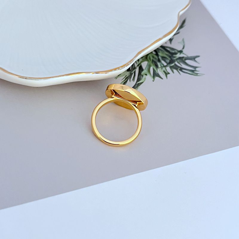  Clean shot of the ring on a light, airy background (like sand-colored or light blue), highlighting the shell detail and enamel color.