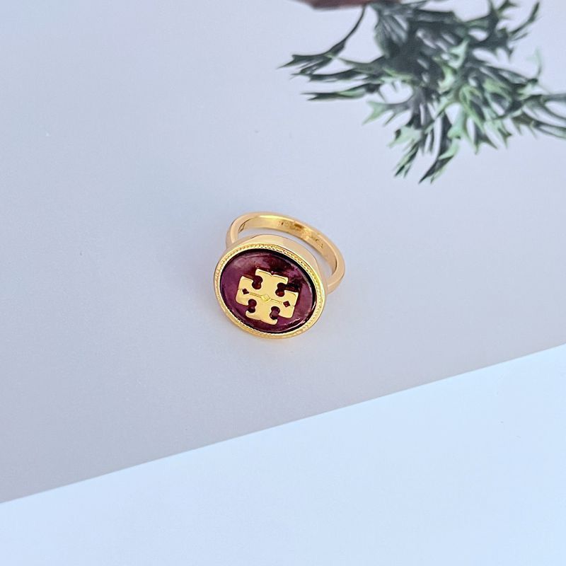 Macro shot focused on the intricately sculpted shell motif and the smooth, glossy enamel section.