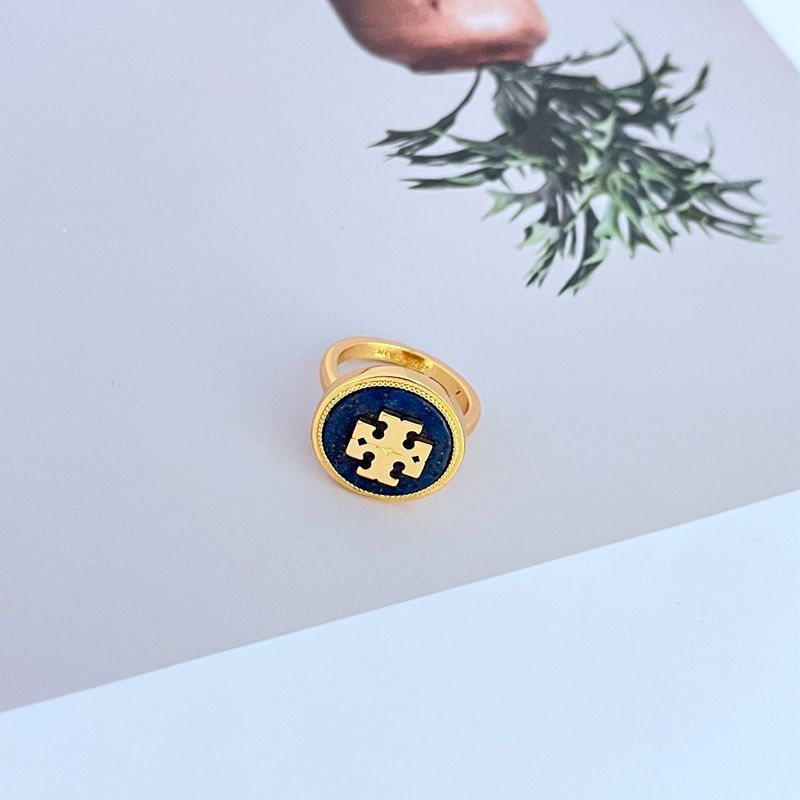 Macro shot focused on the intricately sculpted shell motif and the smooth, glossy enamel section.