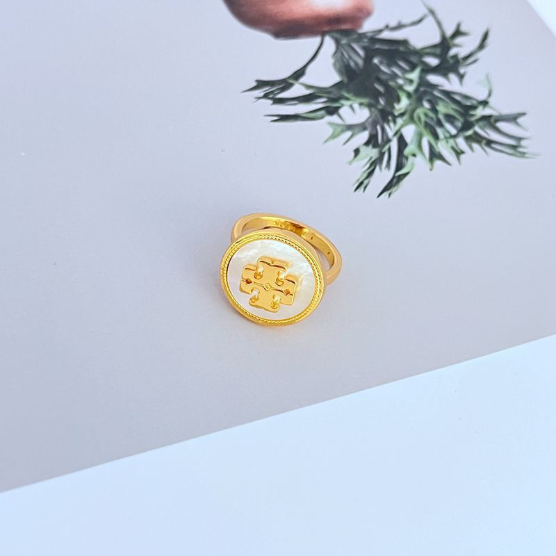  Clean shot of the ring on a light, airy background (like sand-colored or light blue), highlighting the shell detail and enamel color.