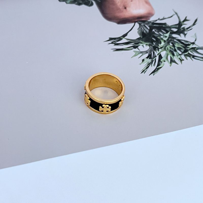  An individual with a modern, monochromatic outfit (all-black or all-white), using the ring as a striking focal point.