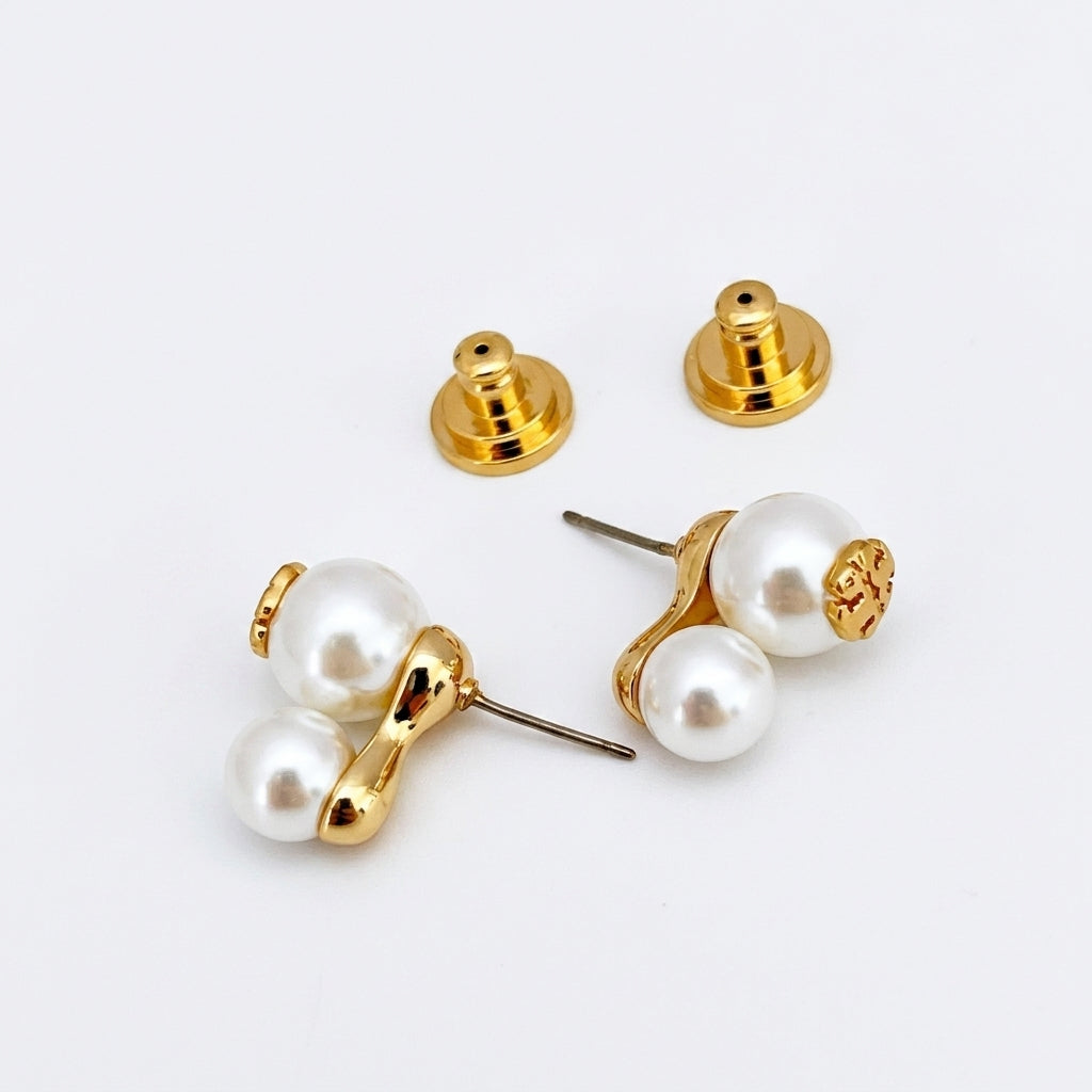 Pair of pearl earrings with gold posts on a white background