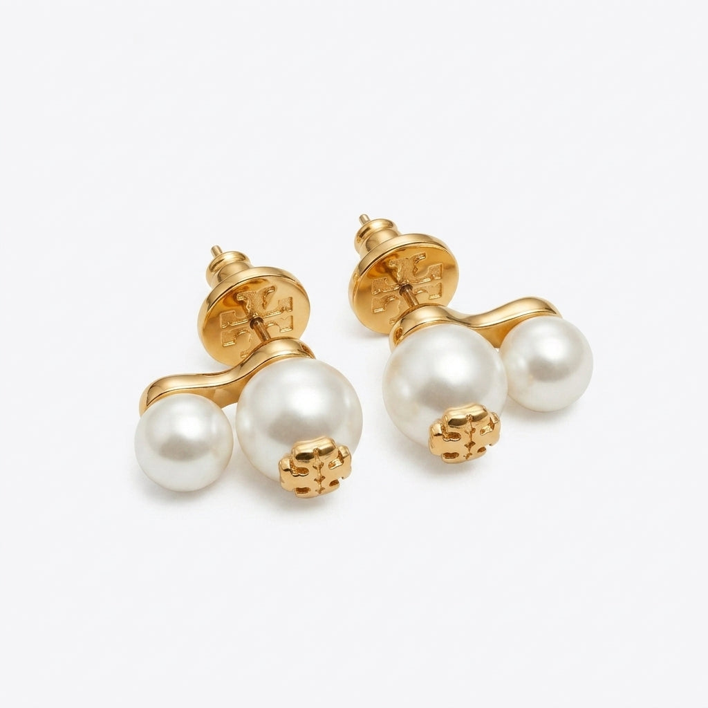 Pearl earrings with gold accents on a white background