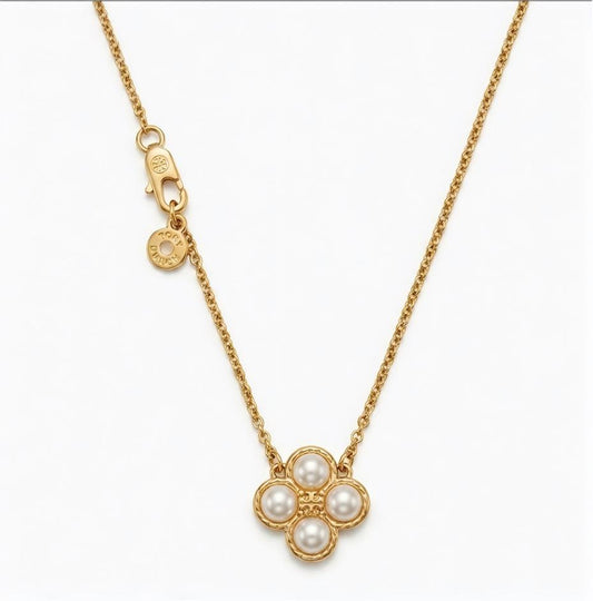 A gold chain necklace featuring a flower-shaped pendant with five white pearls, shown against a plain white background.