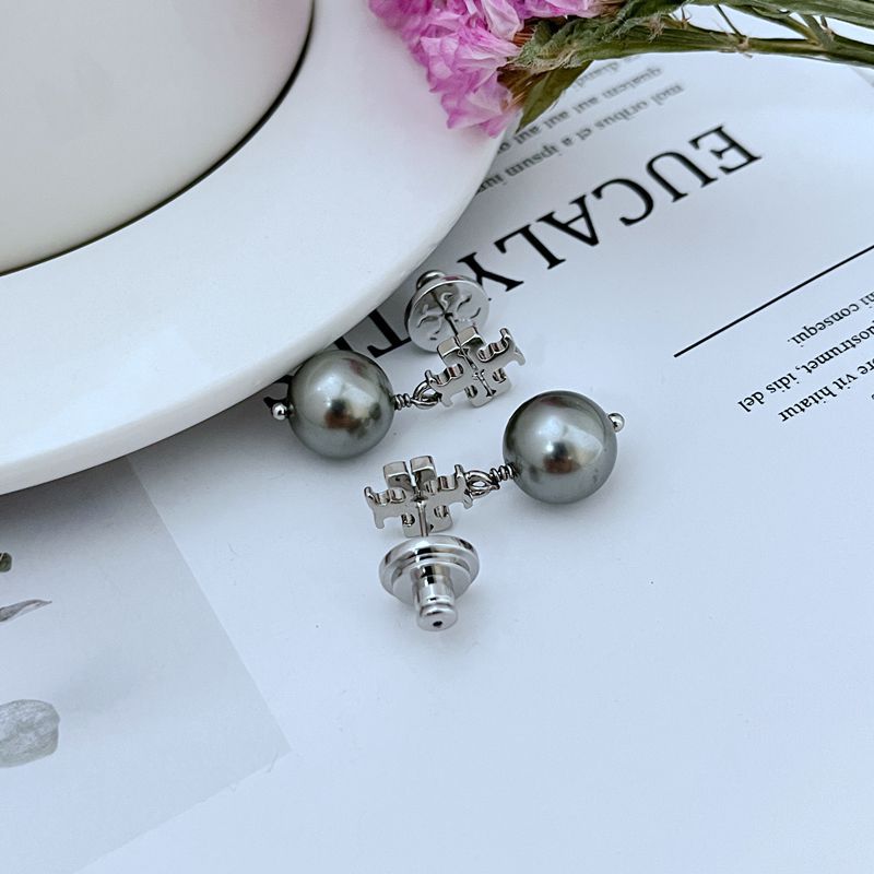 Macro shot focused on the faux pearl, highlighting its smooth, lustrous surface and realistic appearance.