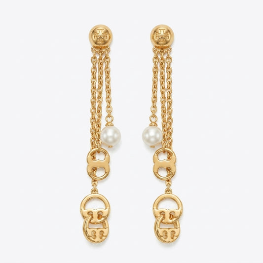 A pair of gold dangle earrings with triple chain drops, white pearl beads, and interlocking gold logo charms at the bottom, shown on a light gray background.