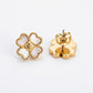 Gold flower-shaped earrings on a white background