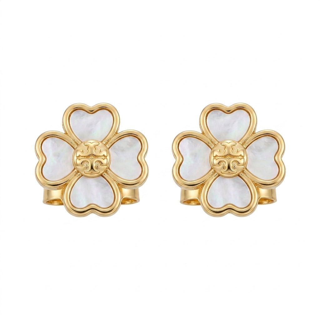 Gold and white floral earrings on a white background