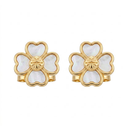 Gold and white floral earrings on a white background