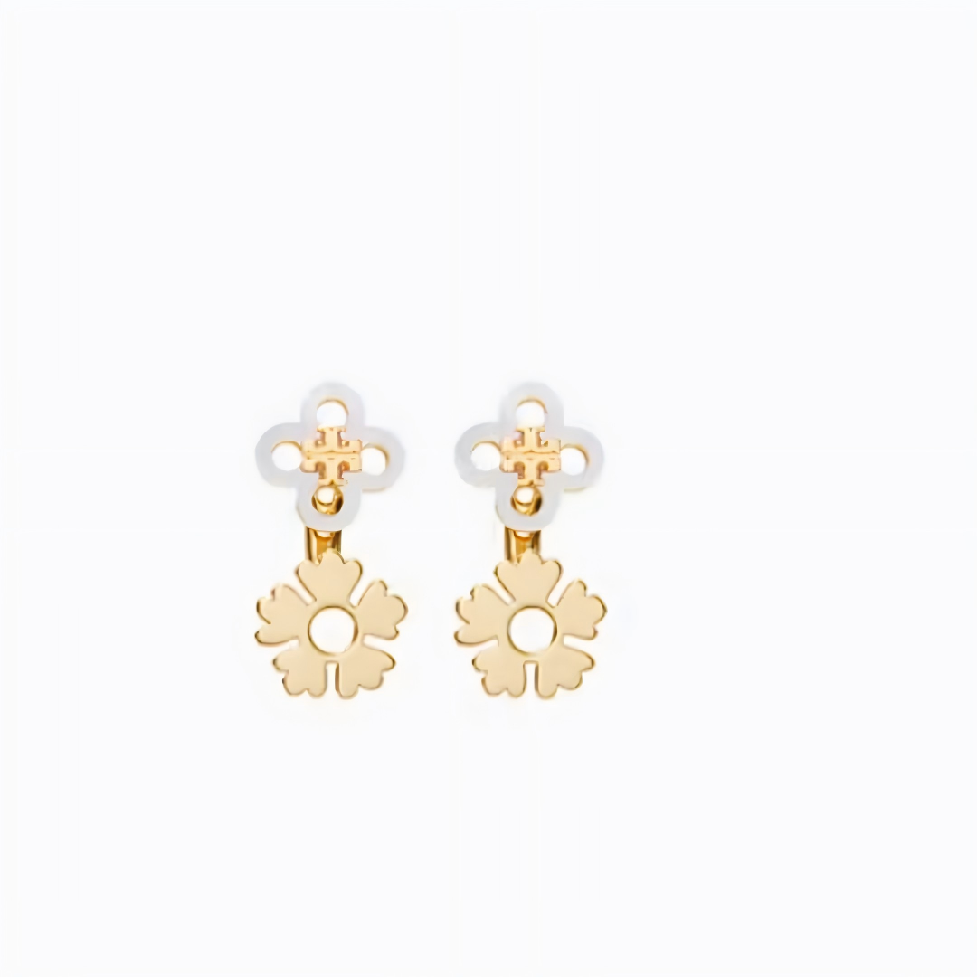 A pair of gold-tone flower-shaped dangle earrings with white enamel clover studs, shown on a plain white background.