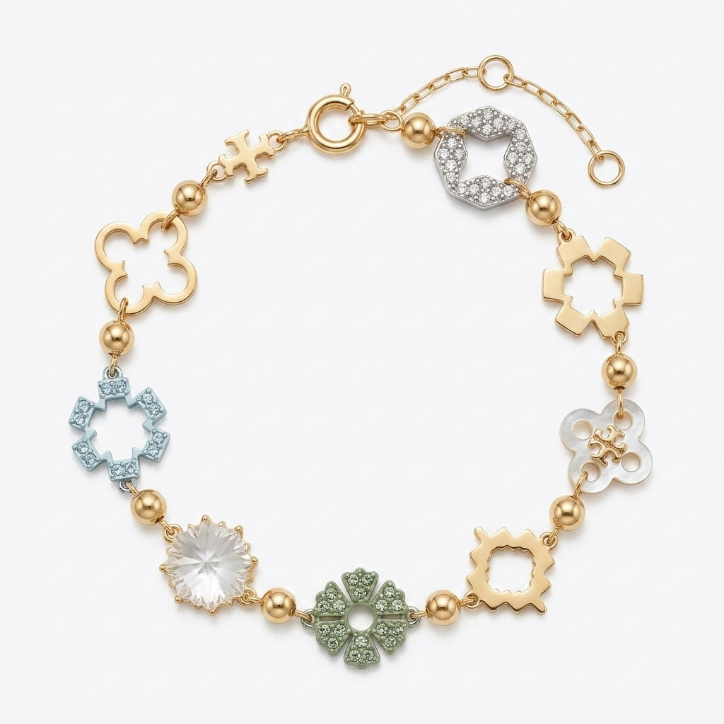 A gold-plated link bracelet featuring multiple decorative charms, including clover, flower, and ring motifs, some embellished with clear crystals, light blue, green, and white stones, set against a plain white background.