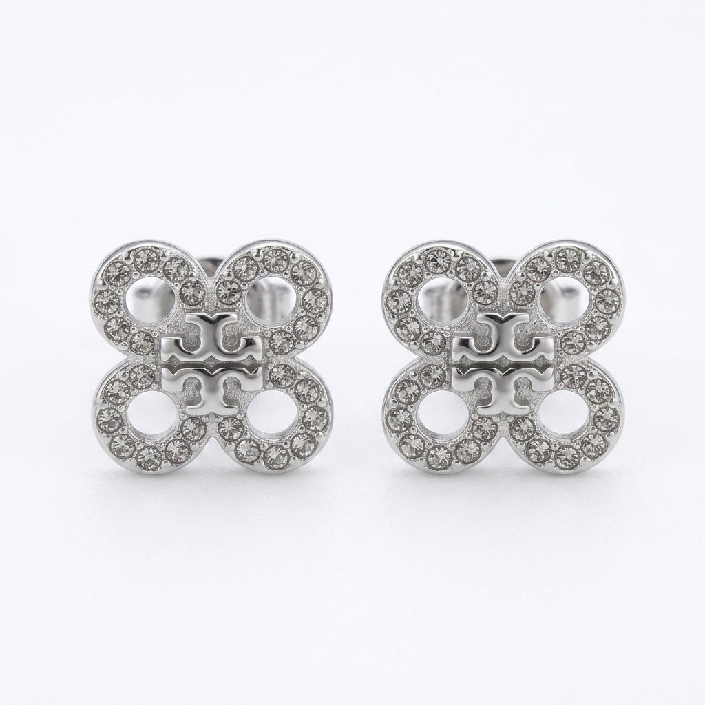 Butterfly-shaped earrings with gemstones on a white background