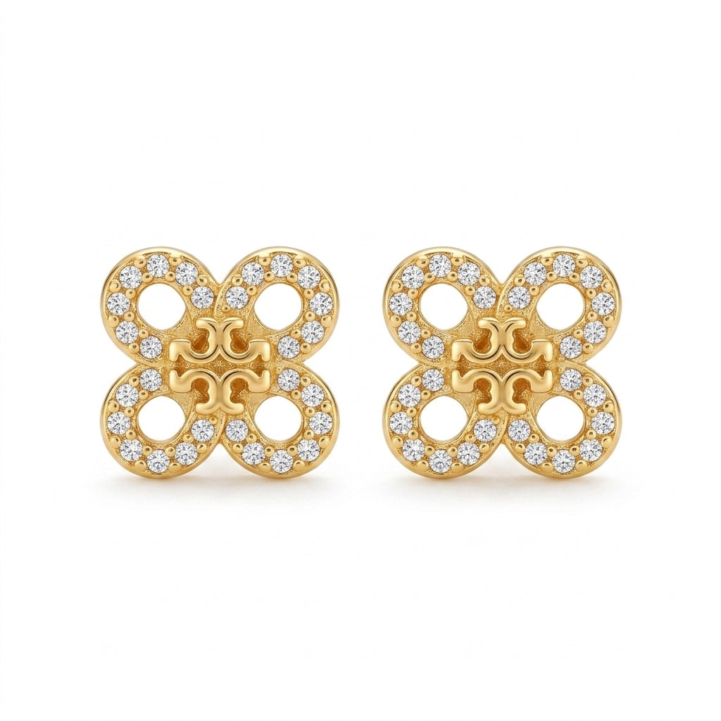 Gold earrings with diamond accents on a white background