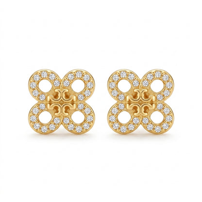 Gold earrings with diamond accents on a white background