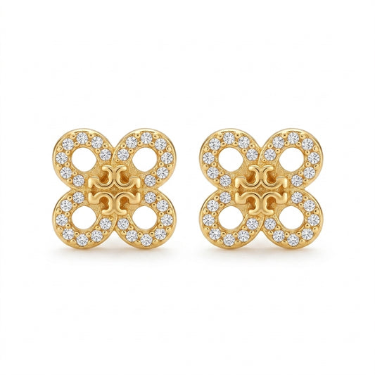 Gold earrings with diamond accents on a white background