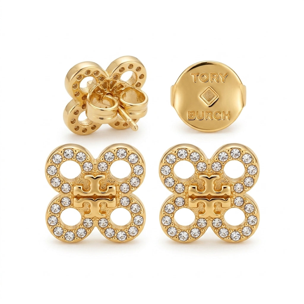 Gold butterfly earrings with clear stones and Tory Burch logo on a white background